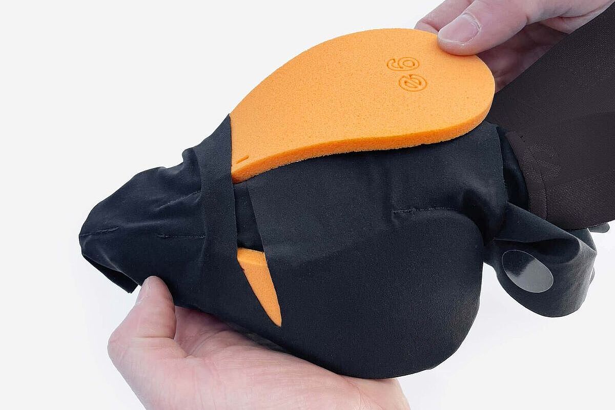 Großaufnahme des Sitzbereichs der Everve-Me-Radhose, die ausgestülpt wurde, so dass die austauschbaren Sitzpolster zu sehen sind. Zu sehen sind zwei Hände, die die Hose halten. 
